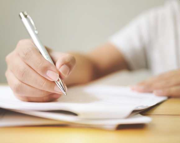 A hand holding a pen